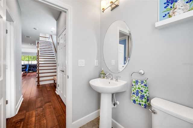 bathroom featuring toilet and wood-type flooring