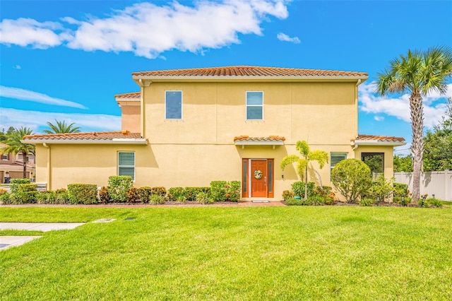 mediterranean / spanish-style house with a front lawn