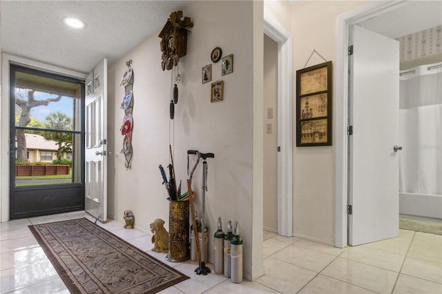 interior space featuring a textured ceiling and light tile patterned floors