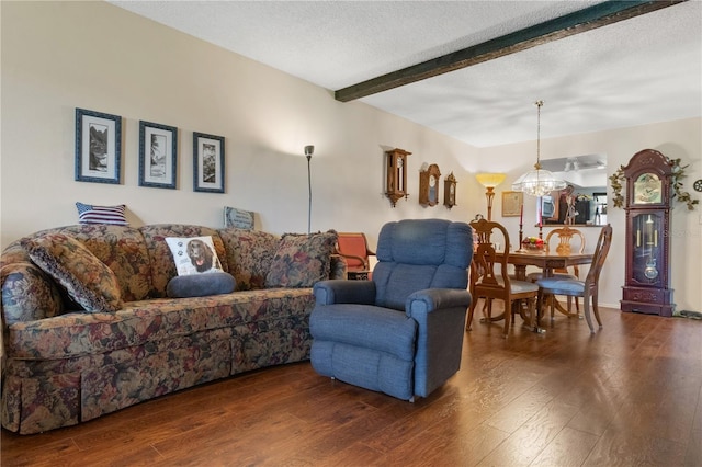 living room featuring a textured ceiling, wood-type flooring, beamed ceiling, and a chandelier