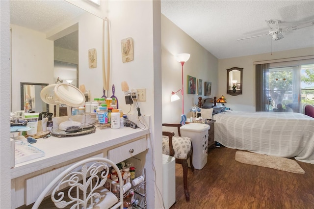 bedroom with a textured ceiling and wood finished floors