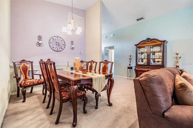 carpeted dining space with a chandelier