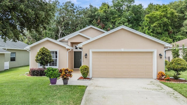 view of front of property with a front yard and a garage