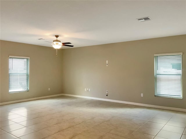 unfurnished room with light tile patterned floors and ceiling fan