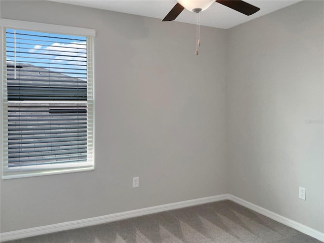 spare room with ceiling fan and carpet