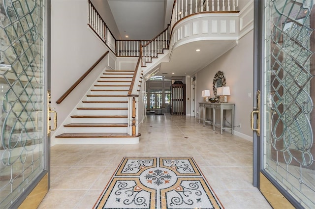 tiled foyer entrance with a towering ceiling