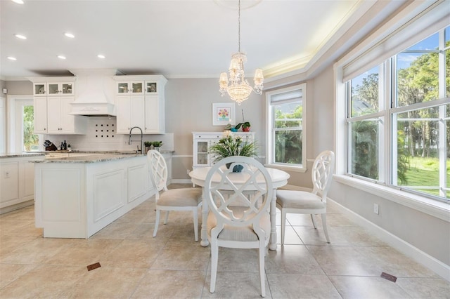 dining room featuring a chandelier, ornamental molding, and a wealth of natural light