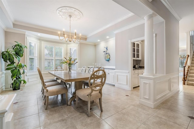 dining room featuring ornate columns, crown molding, and a chandelier