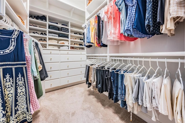 walk in closet featuring light carpet