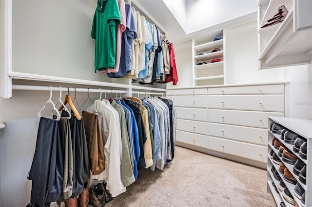 walk in closet featuring light colored carpet