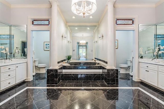 bathroom with a tub, vanity, and toilet