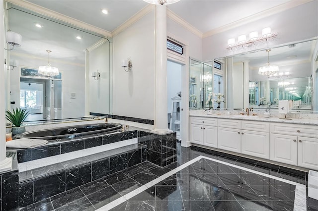 bathroom featuring decorative columns, crown molding, vanity, and tiled bath