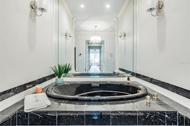 bathroom featuring crown molding and tiled tub