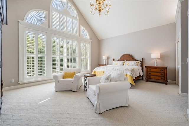 carpeted bedroom with a notable chandelier and high vaulted ceiling