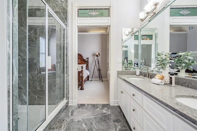 bathroom with vanity and a shower with door