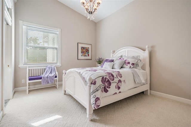 carpeted bedroom with lofted ceiling and an inviting chandelier