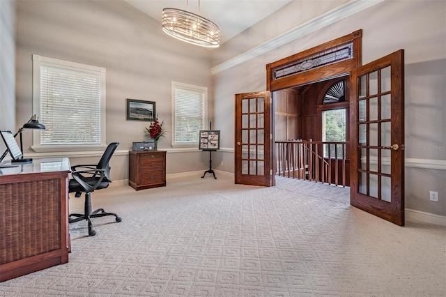 office area with plenty of natural light, french doors, light colored carpet, and a notable chandelier