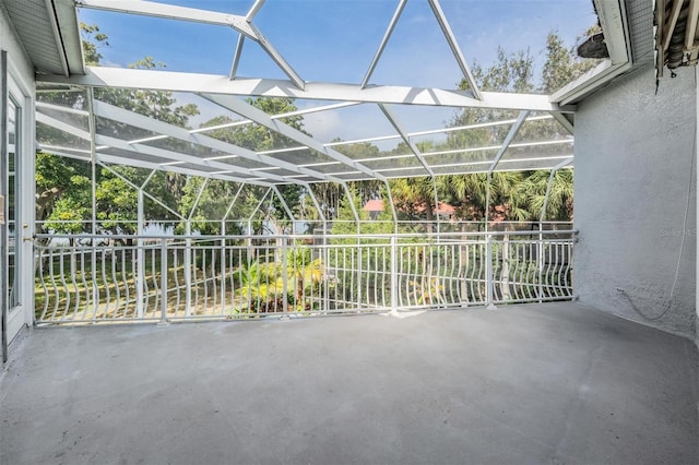 view of patio featuring glass enclosure