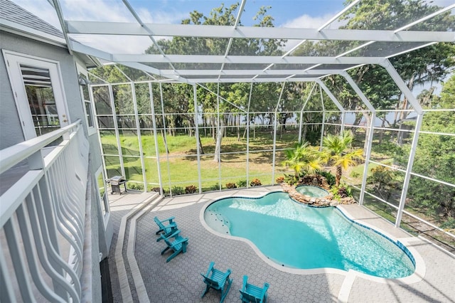 view of pool with a yard, a patio area, and a lanai