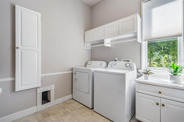 washroom featuring cabinets, separate washer and dryer, and light tile patterned floors