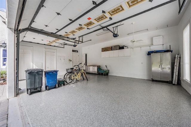 garage featuring ceiling fan and a garage door opener