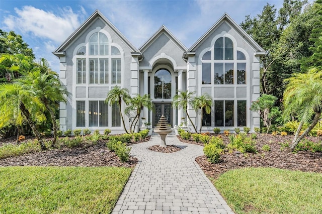 tudor-style house with a front yard