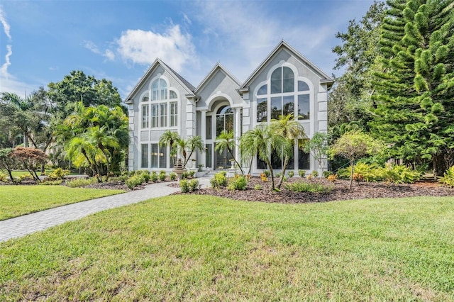 english style home with a front lawn