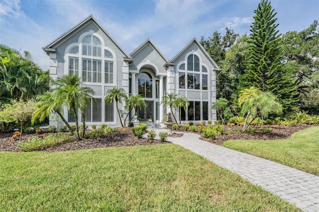 english style home with a front lawn