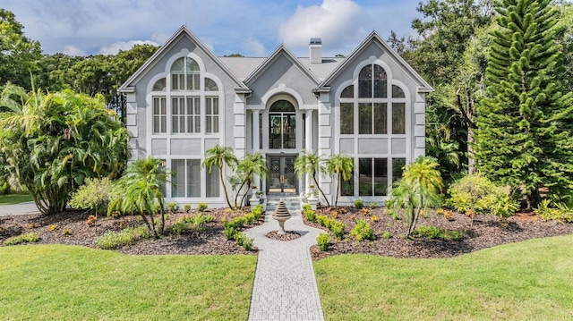 tudor house featuring a front lawn