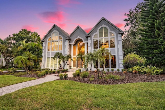 english style home with a yard