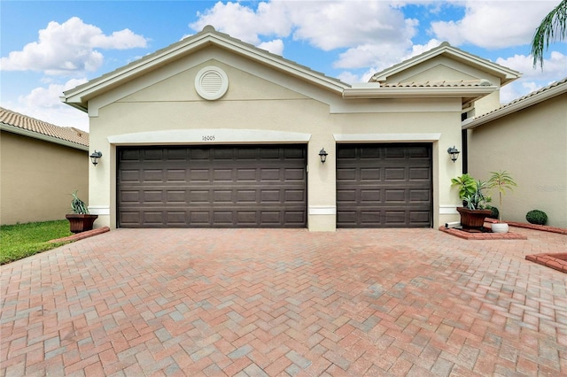 garage with decorative driveway