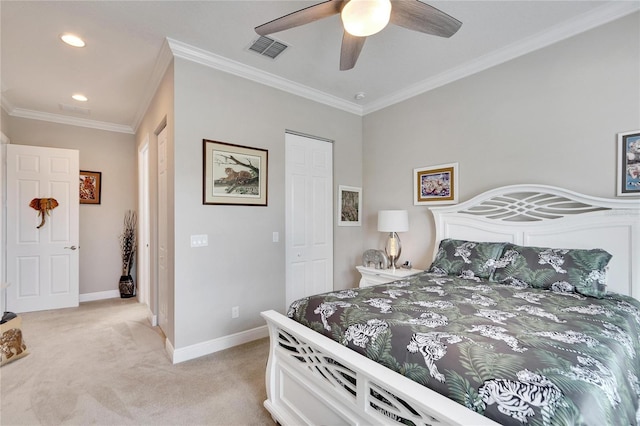 carpeted bedroom featuring ornamental molding, ceiling fan, and a closet