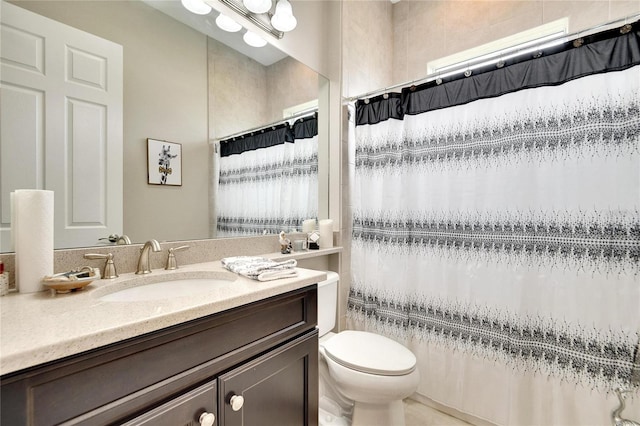 bathroom with toilet, vanity, and a shower with curtain