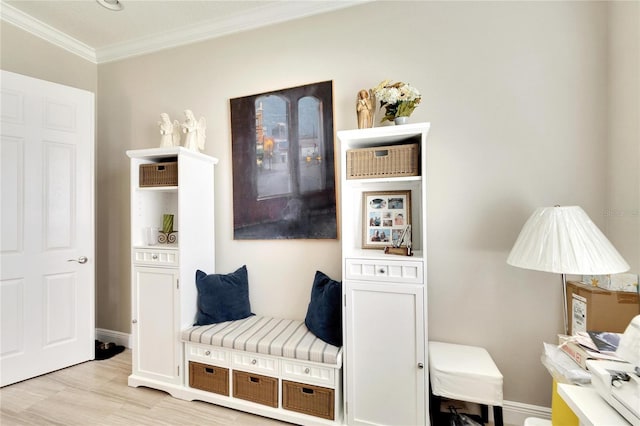 interior space with light wood finished floors, baseboards, and ornamental molding