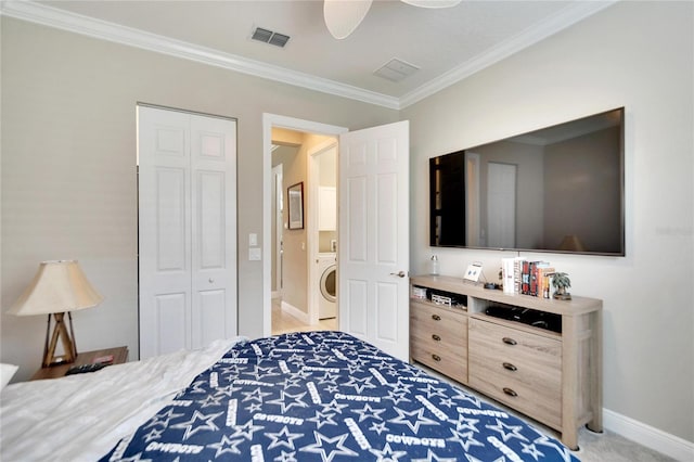 bedroom with ornamental molding, ceiling fan, a closet, light colored carpet, and washer / clothes dryer