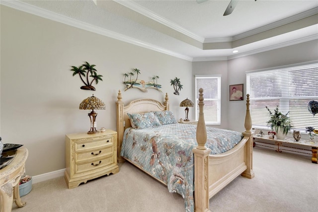 bedroom featuring crown molding, a ceiling fan, a raised ceiling, baseboards, and light colored carpet