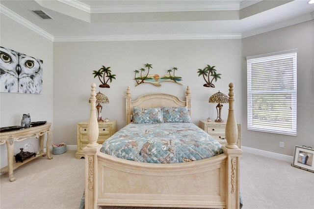 bedroom with ornamental molding, a raised ceiling, and light colored carpet