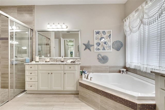 bathroom featuring vanity, a stall shower, and a bath