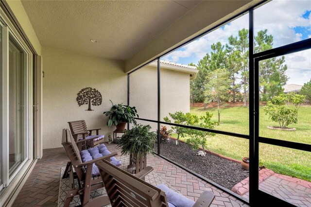 sunroom / solarium featuring a healthy amount of sunlight