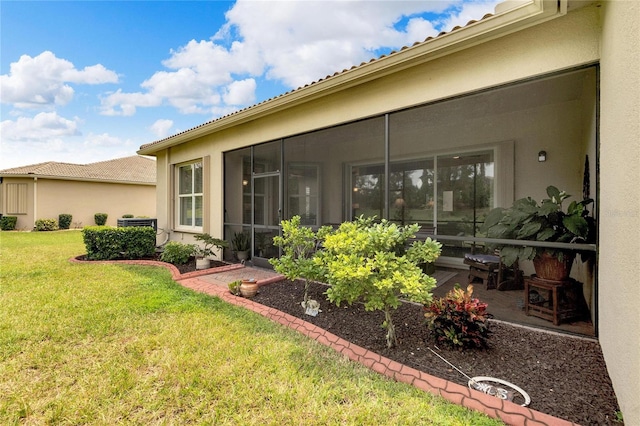 view of yard featuring cooling unit, a sunroom, and a patio area