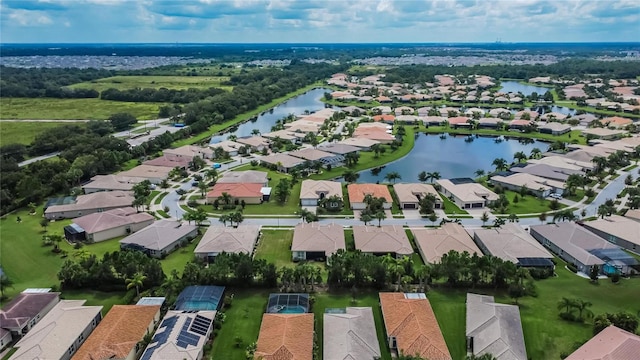 drone / aerial view with a water view and a residential view