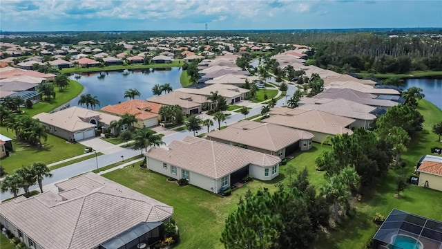 drone / aerial view featuring a residential view and a water view