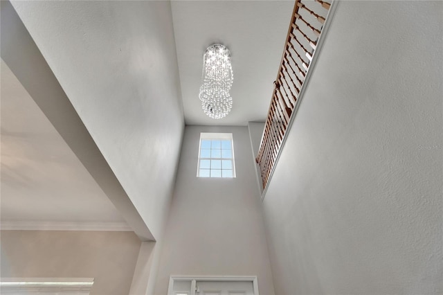 details featuring an inviting chandelier and ornamental molding