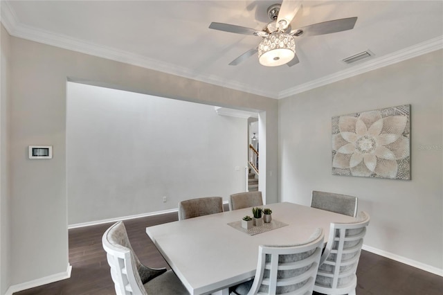 dining room featuring ceiling fan, crown molding, and dark hardwood / wood-style flooring