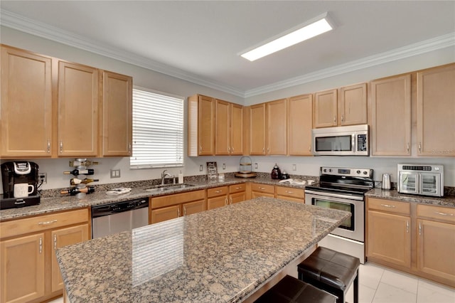 kitchen with stainless steel appliances, crown molding, a kitchen bar, a center island, and sink