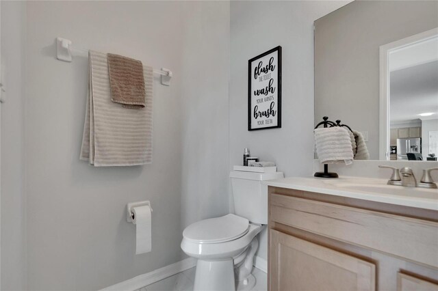 bathroom with vanity and toilet