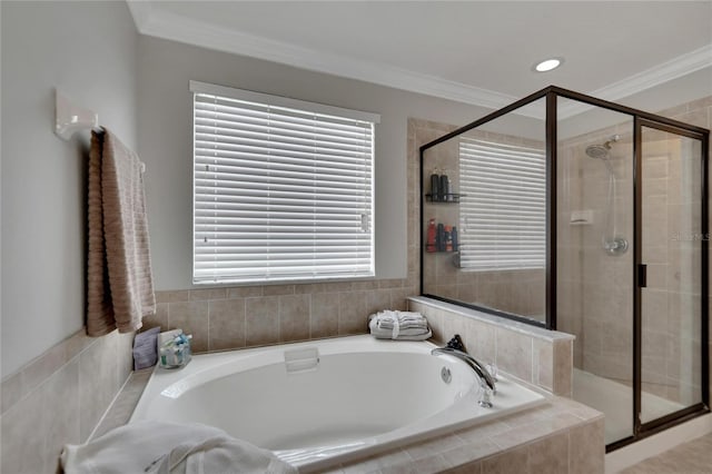 bathroom with independent shower and bath, plenty of natural light, and ornamental molding