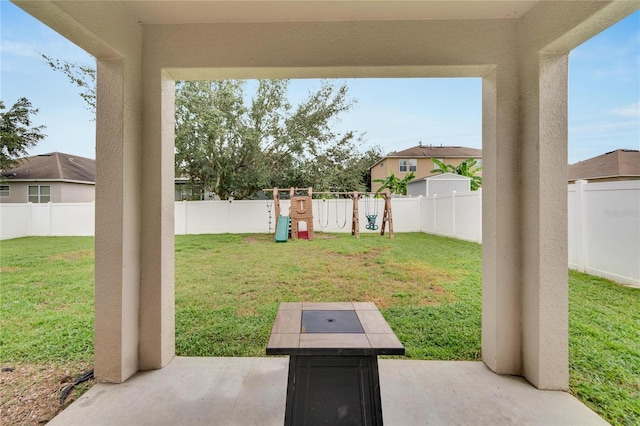 view of yard featuring a patio and a playground