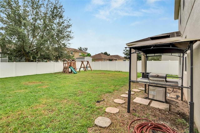 view of yard featuring a playground and a gazebo