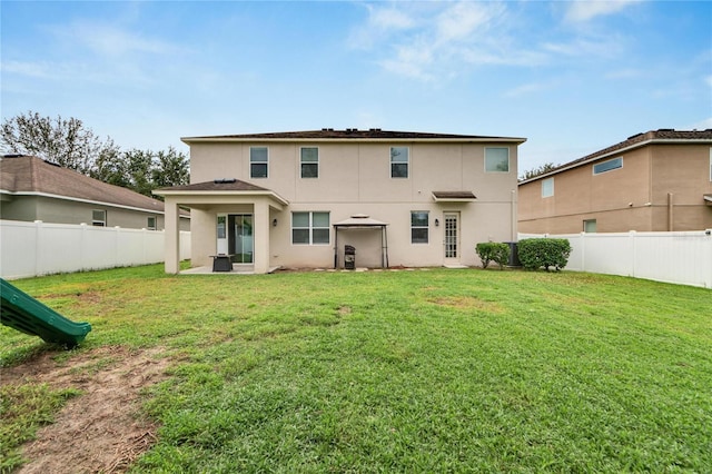 back of property featuring a yard and a patio area